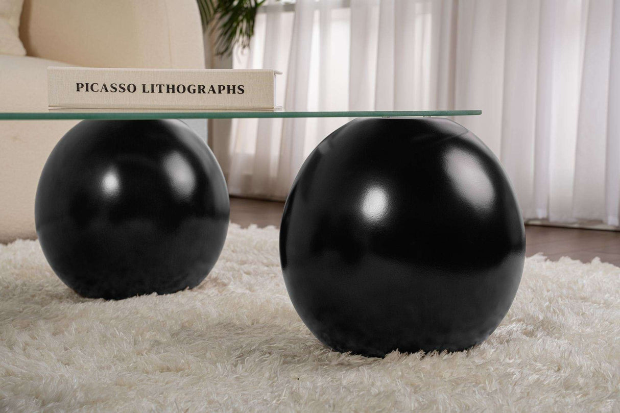 Deens ovale salontafel transparant glas zwarte bolpoten Evara 118x75 cm